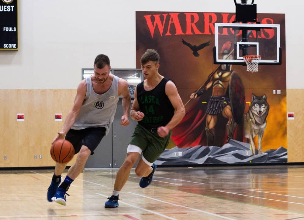 Two players competing for basketball